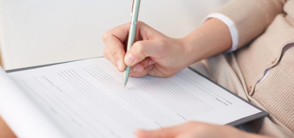 Female counselor writing down some information about her patient